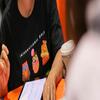 female student with international owls t-shirt smiling