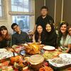 Family and students posing at the dinner table