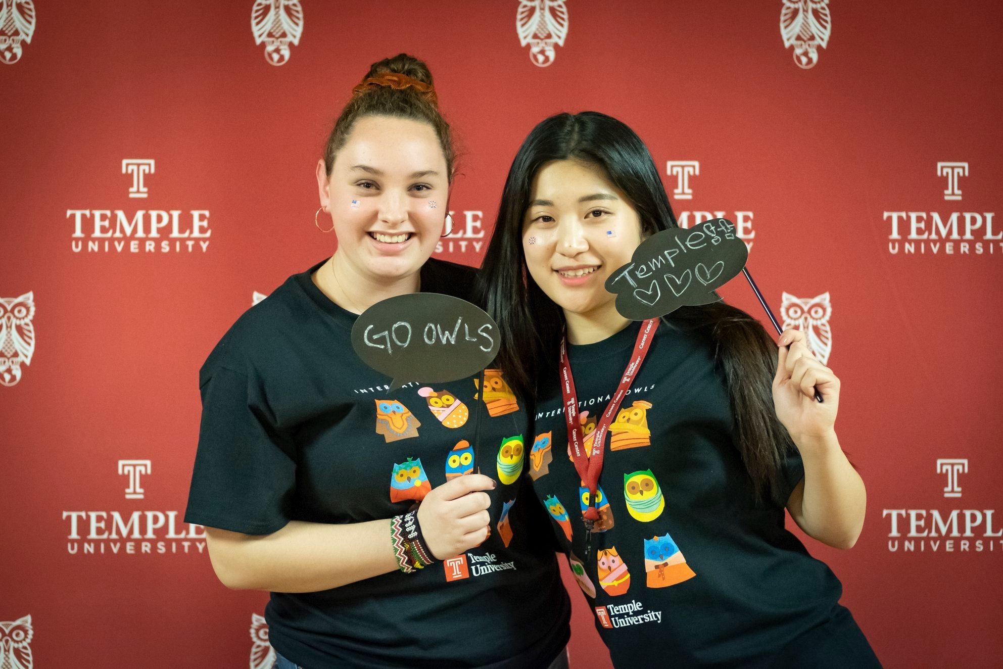 Two students posing at the selfie wall
